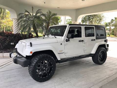 2014 Jeep Wrangler Unlimited for sale at DENMARK AUTO BROKERS in Riviera Beach FL